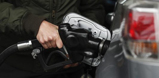 Un conductor carga gasolina en California, donde el precio del galón superó los $5.