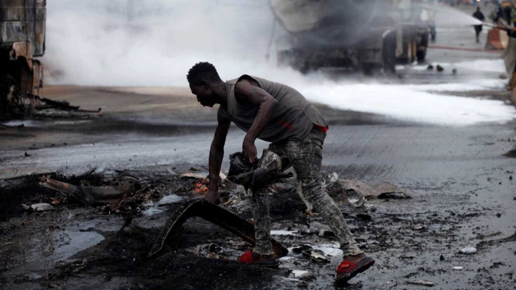 Foto referencial. Un hombre recoge restos tras la explosión de un tanquero en Nigeria.