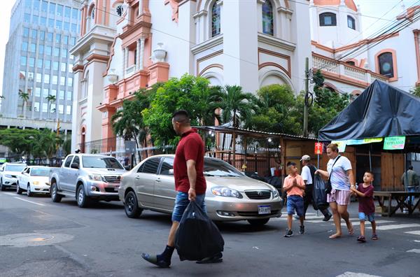 Registro. Hondureños regresan a sus hogares tras culminar su jornada laboral en San Pedro Sula. EFE